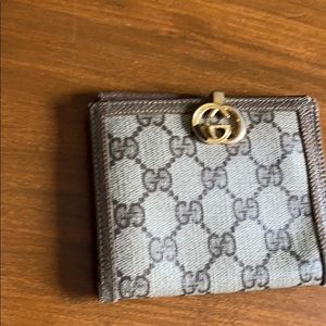 Gucci brown wallet with fold over clasp.